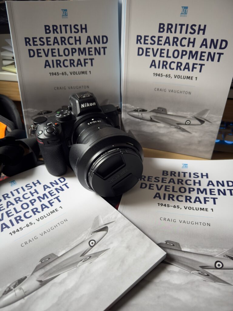 My camera surrounded by my authors copies of my book.