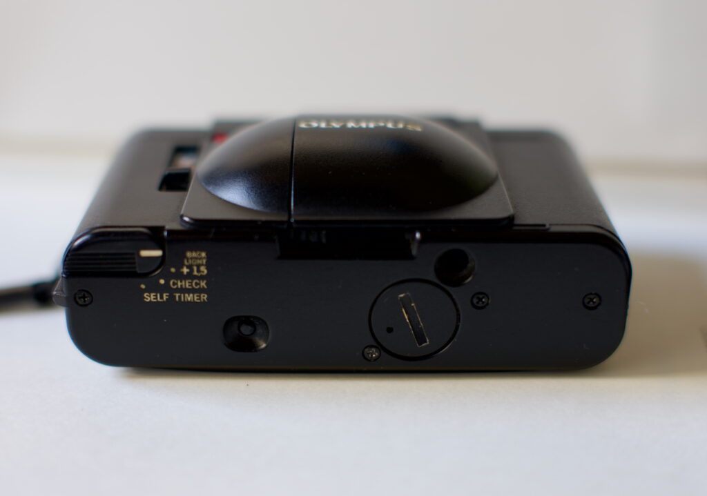 XA bottom view, with the exposure compensation, timer and battery check switch.