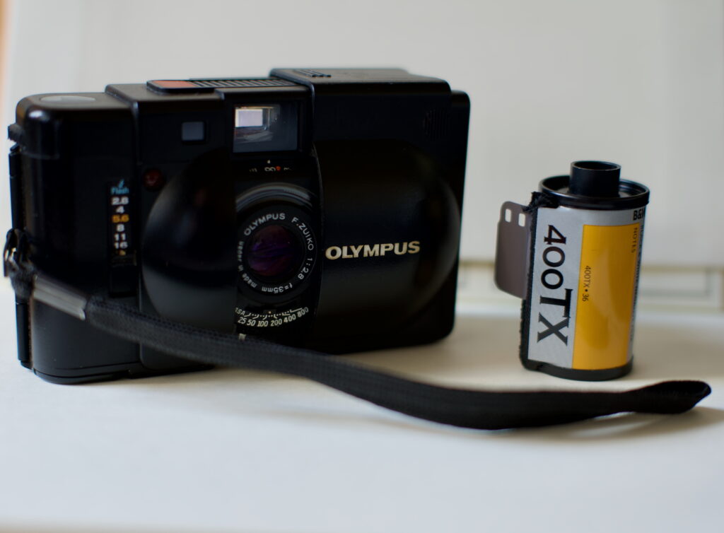 Olympus XA with a 35mm film at the side for comparison.
