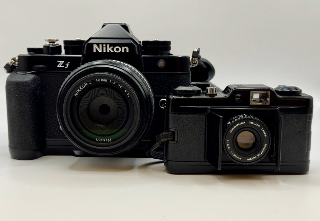 Nikon Zf digital camera beside a Chinon Bellami 35mm compact