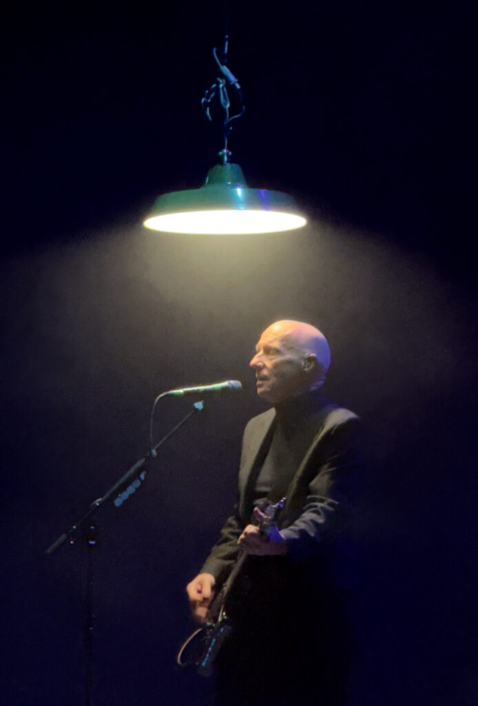 Singer under an overhead light
