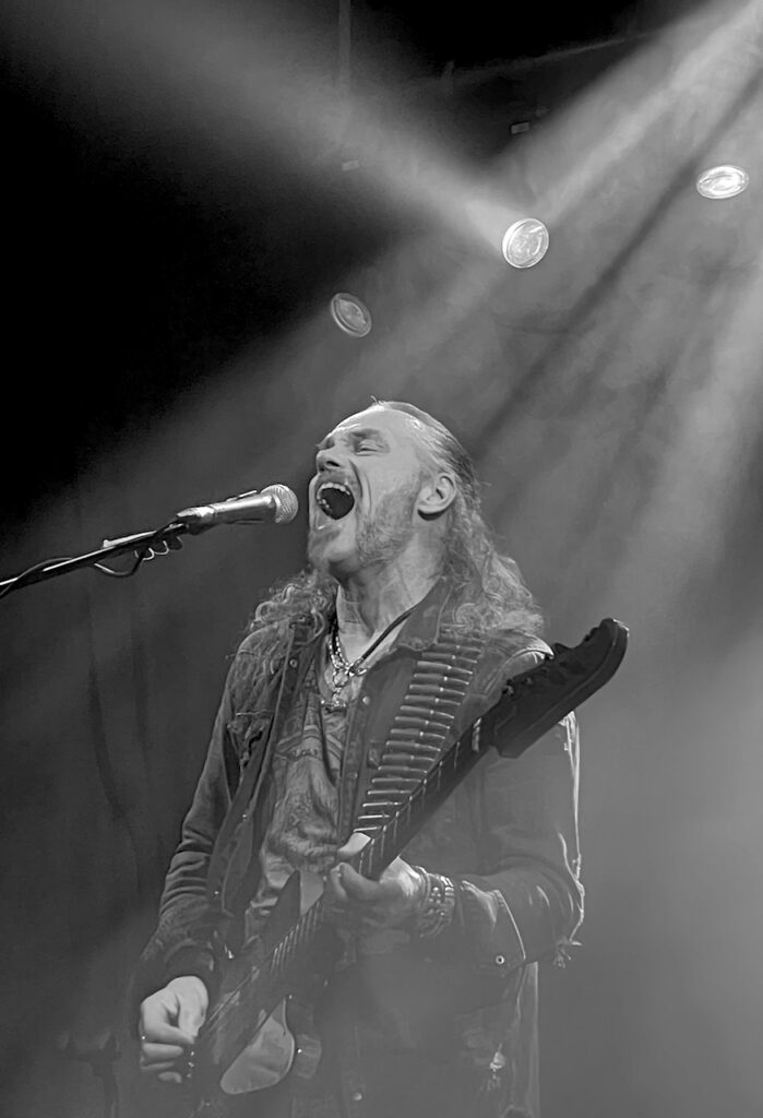 B&W image of a bass guitarist.