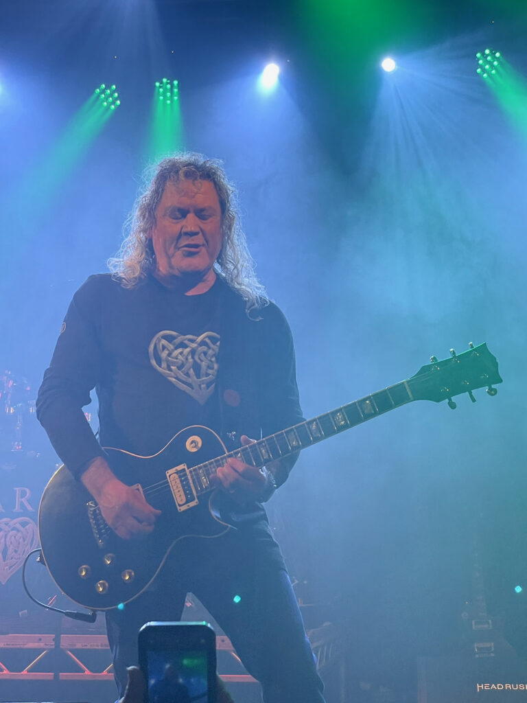 Guitarist in hazy fog with spotlights