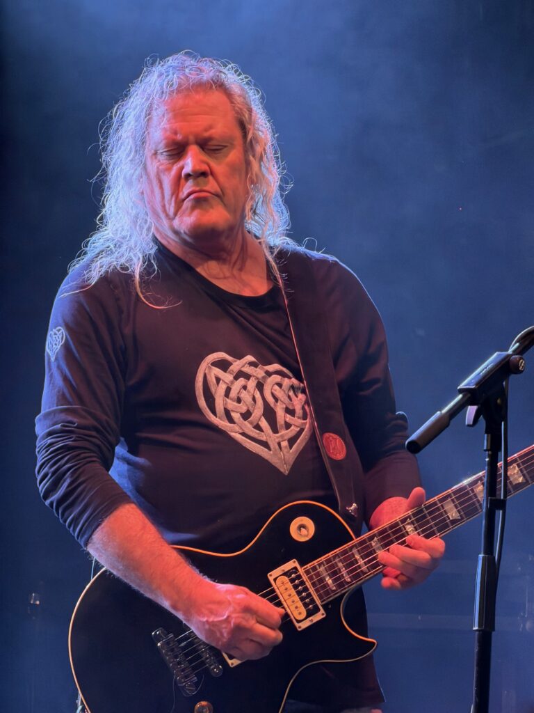 Vinny Burns plays guitar