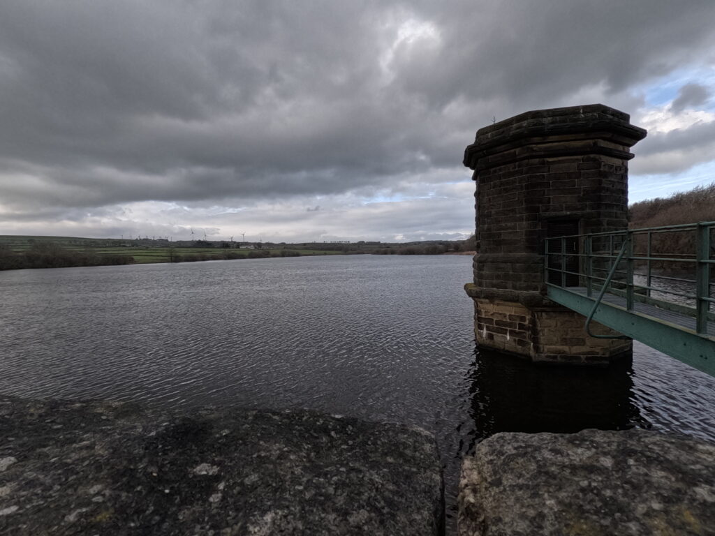 A view across a reservoir wall and the stone control tower